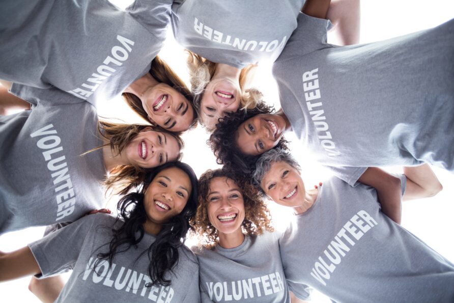 Group of volunteers in a circle looking down