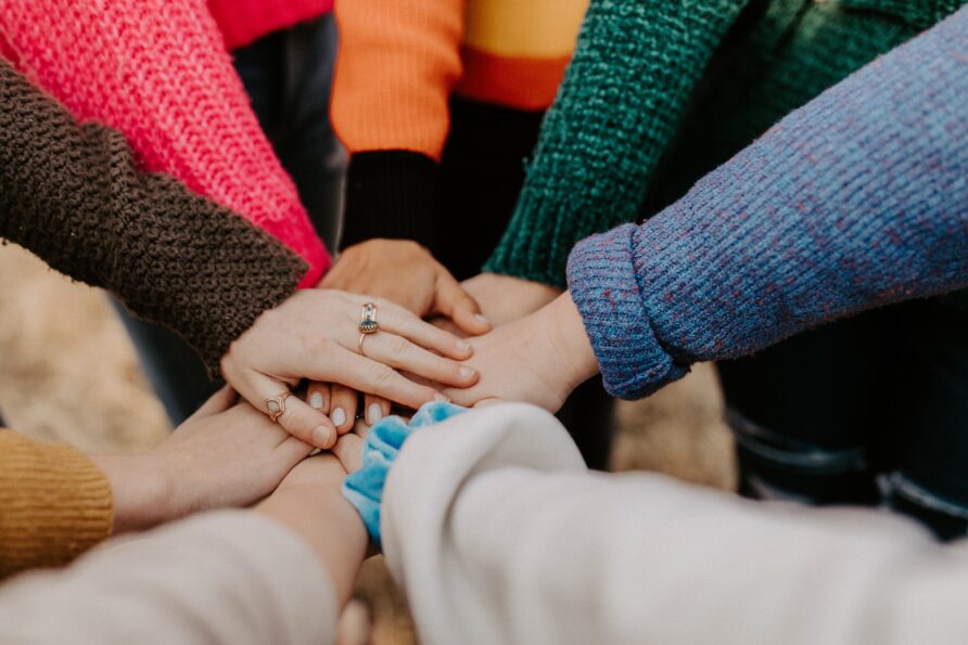 Group of people in a circle holding hands